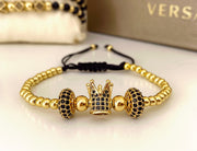 Bratara model margele aurii si coroana cu pietricele negre